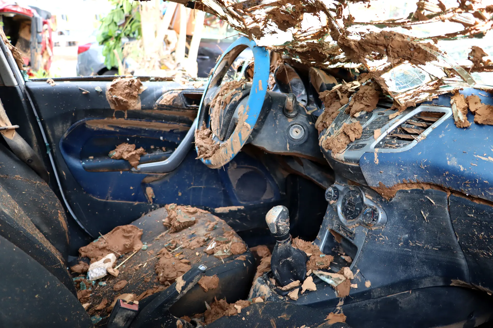 El interior del vehículo, lleno de barro y que recuerda a un día agotador en el sector del transporte, está sembrado de escombros que cubren el volante, los asientos y el tablero.