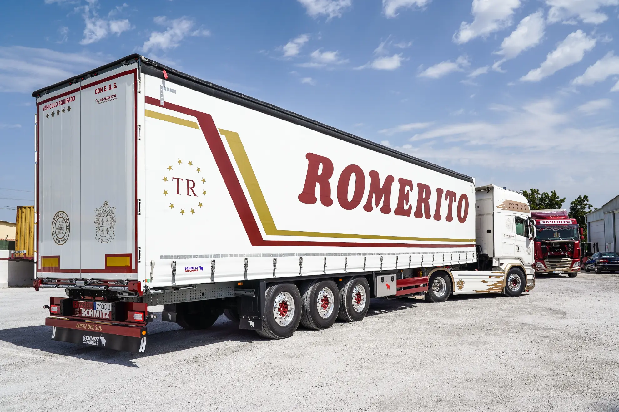 Un gran semirremolque blanco con el texto "Borrador automático" en rojo y dorado en el lateral.