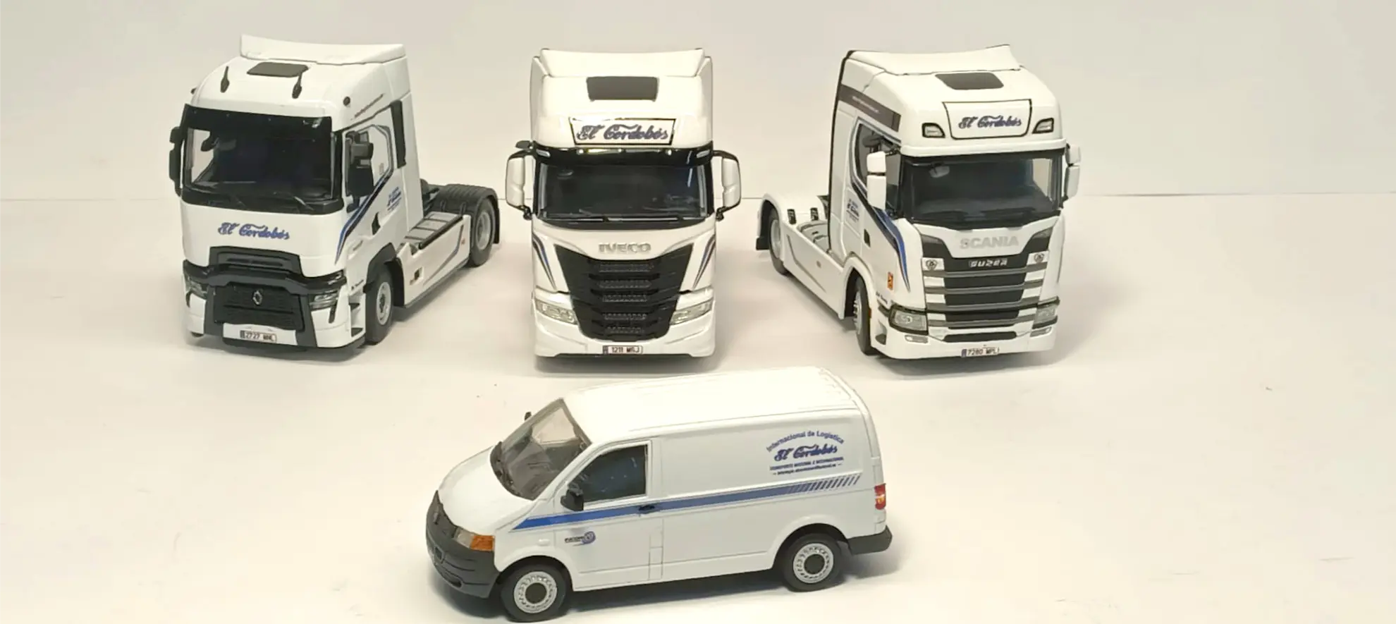 Cuatro maquetas blancas de vehículos, tres camiones y una furgoneta, con la marca "El Cidón", perfectas para coleccionismo de camiones o como inspiración para una réplica camión personalizada, expuestas sobre un fondo liso.