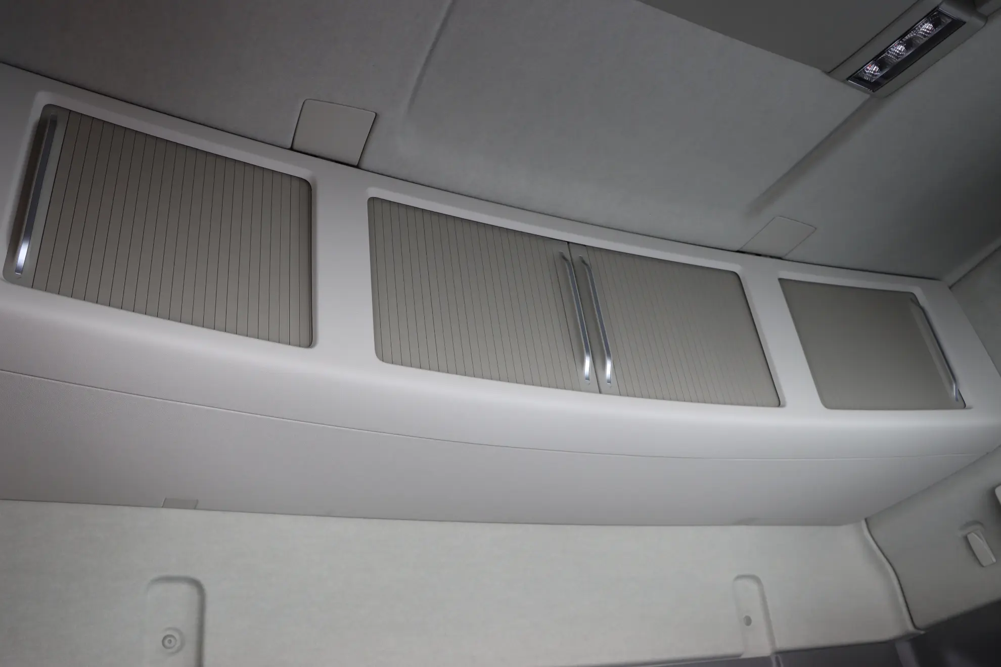 Compartimentos superiores de almacenamiento con puertas correderas cerradas en el interior de la cabina de un vehículo o camión moderno, ideales para cualquier gestor de flotas que busque soluciones organizadas.