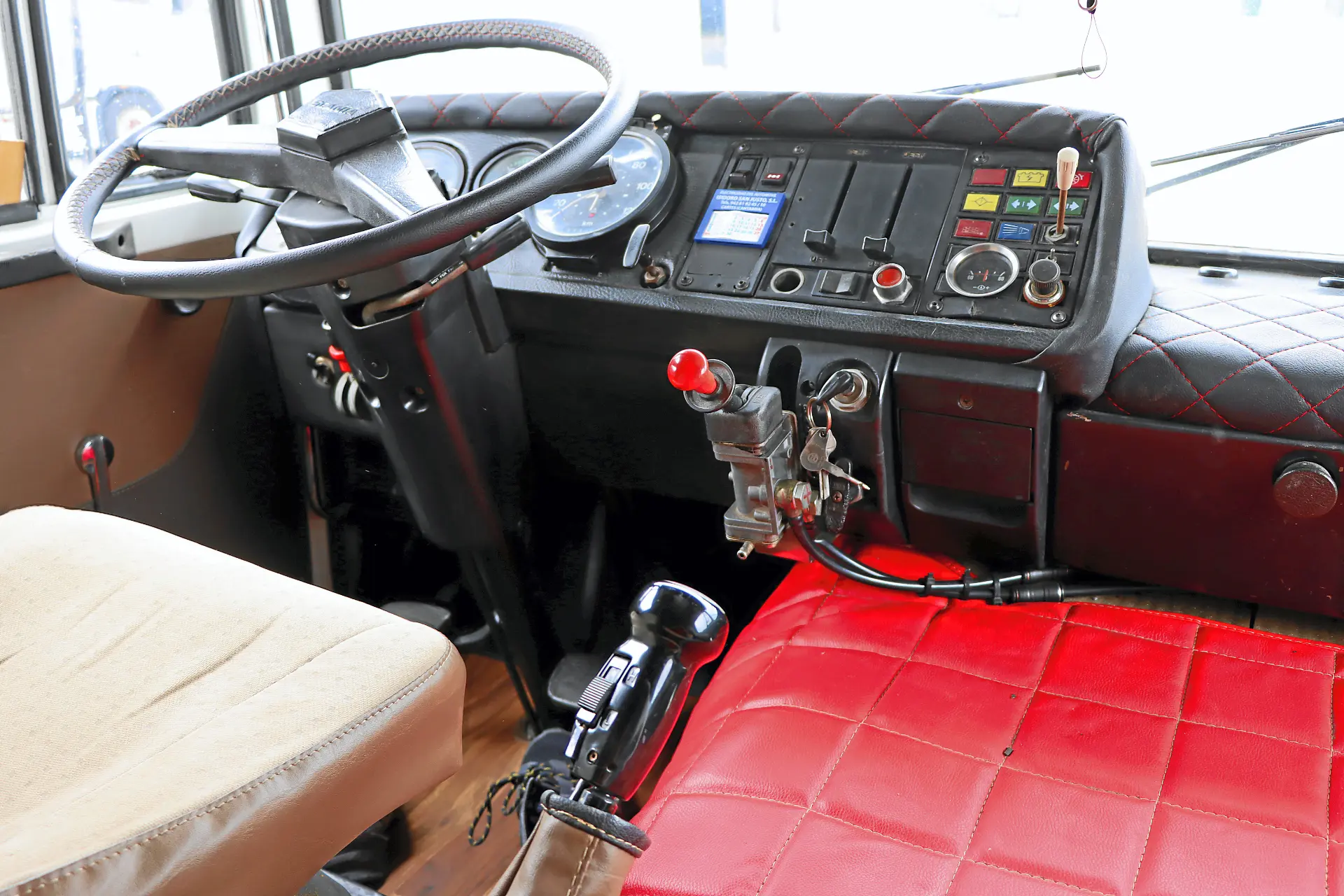 Asiento del conductor del autobús y salpicadero con volante, indicadores y palancas de control, con elementos de diseño clásicos de Cresmotrans.