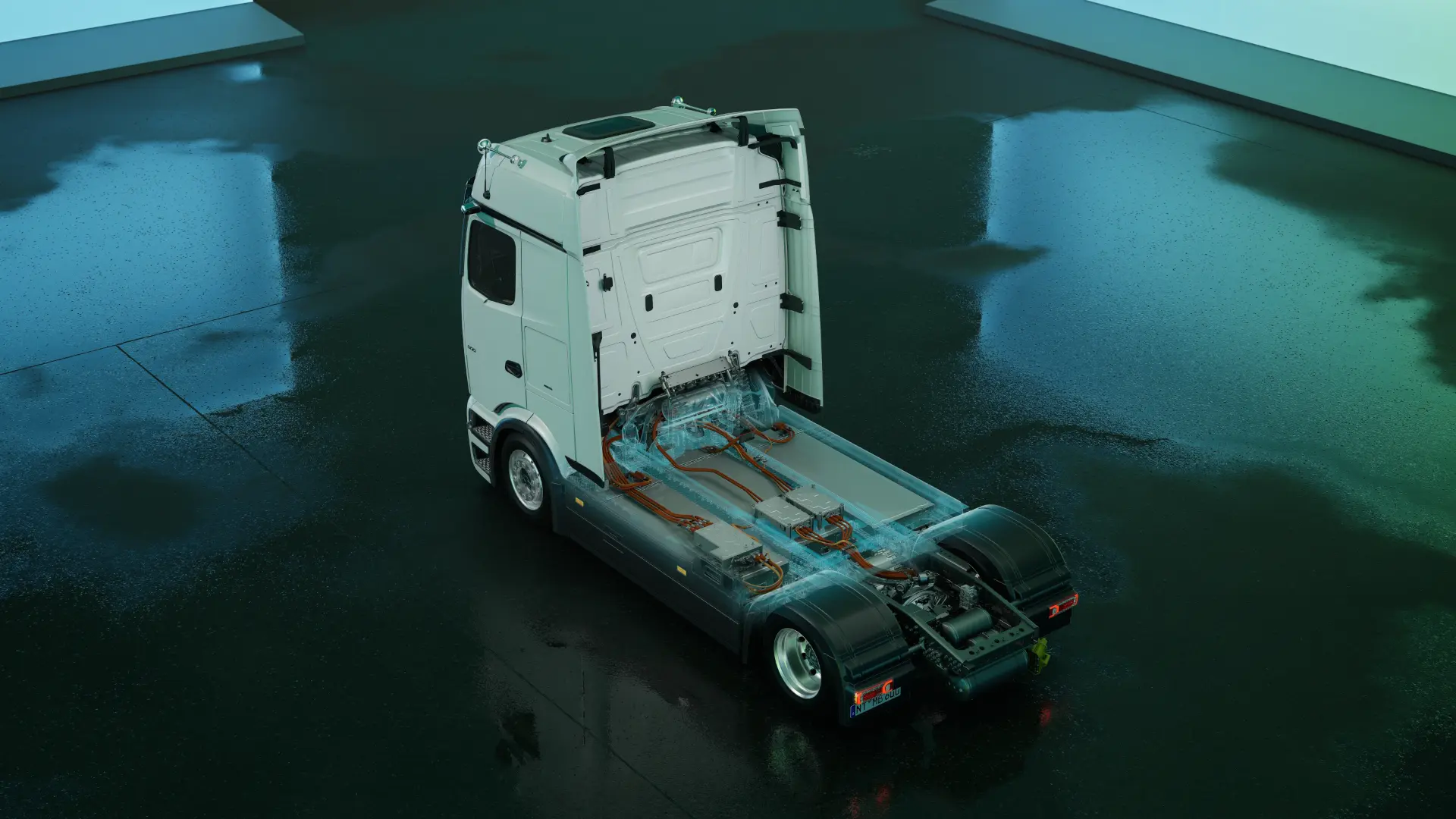 Un camión con la cabina levantada, que deja al descubierto el cableado eléctrico interno y los componentes del chasis, muestra la avanzada tecnología del eActros Lowliner, un camión eléctrico diseñado para el transporte de gran volumen.